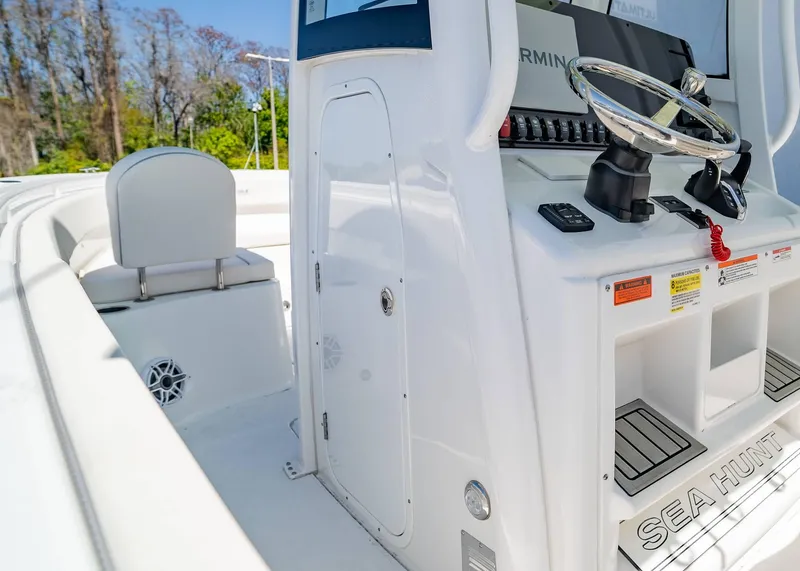 Slide: The Image of 2025 Sea Hunt Gamefish 25 boat interior with steering wheel and seating. - 16