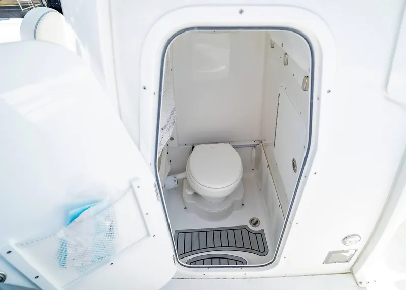 Slide: The Image of 2025 Sea Hunt Gamefish 25 boat interior with compact marine toilet. - 17