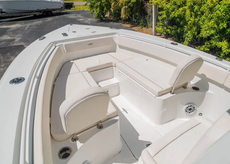 Slide: The Image of 2025 Sea Hunt Gamefish 25 boat interior with white seating and cup holders. - 18