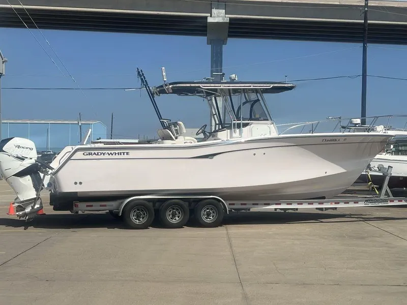 Slide: The Image of 2003 Grady-White 306 Bimini boat on trailer, parked under a bridge. - 1