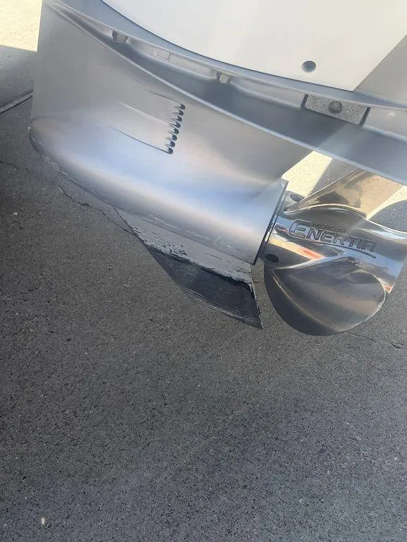 Slide: The Image of Close-up of a 2003 Grady-White 306 Bimini boat propeller on pavement. - 11