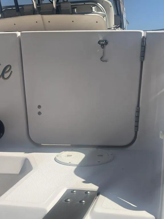 Slide: The Image of 2003 Grady-White 306 Bimini boat deck with storage compartment and latch. - 13