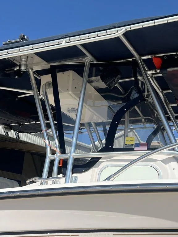 Slide: The Image of 2003 Grady-White 306 Bimini boat with sturdy metal frame and canopy. - 15