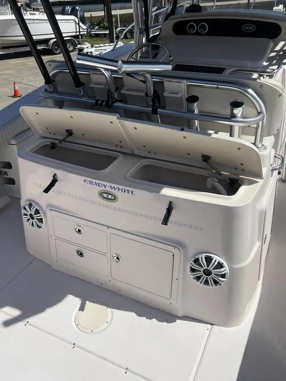Slide: The Image of 2003 Grady-White 306 Bimini boat interior with storage compartments and seating. - 18