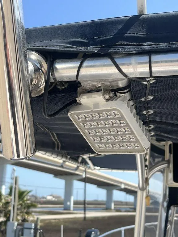 Slide: The Image of LED light fixture on a 2003 Grady-White 306 Bimini boat, under a metal frame. - 21