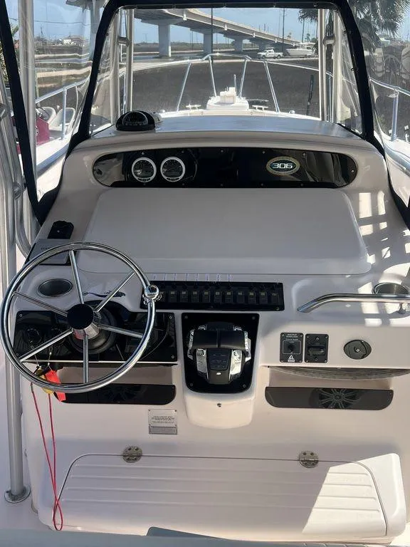 Slide: The Image of 2003 Grady-White 306 Bimini boat helm with steering wheel and control panel. - 22