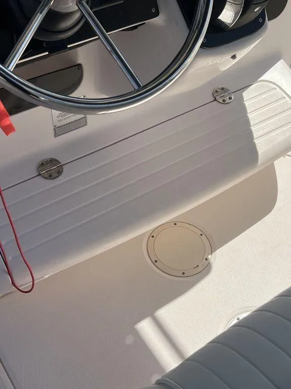 Slide: The Image of 2003 Grady-White 306 Bimini boat cockpit with steering wheel and seating. - 35