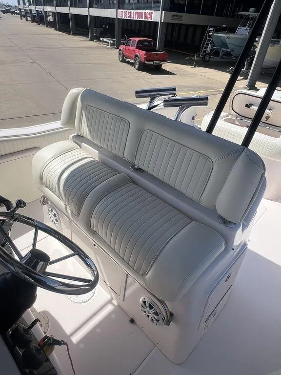 Slide: The Image of 2003 Grady-White 306 Bimini boat interior with cushioned seating and steering wheel. - 36
