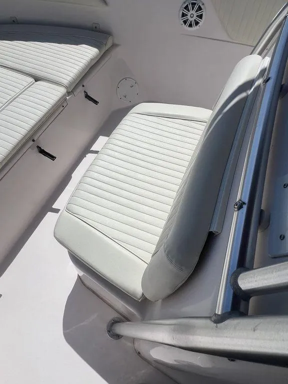 Slide: The Image of 2003 Grady-White 306 Bimini boat interior with white cushioned seating. - 37