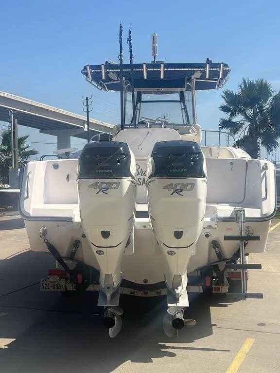 Slide: The Image of 2003 Grady-White 306 Bimini boat with dual outboard engines, parked on a sunny day. - 4