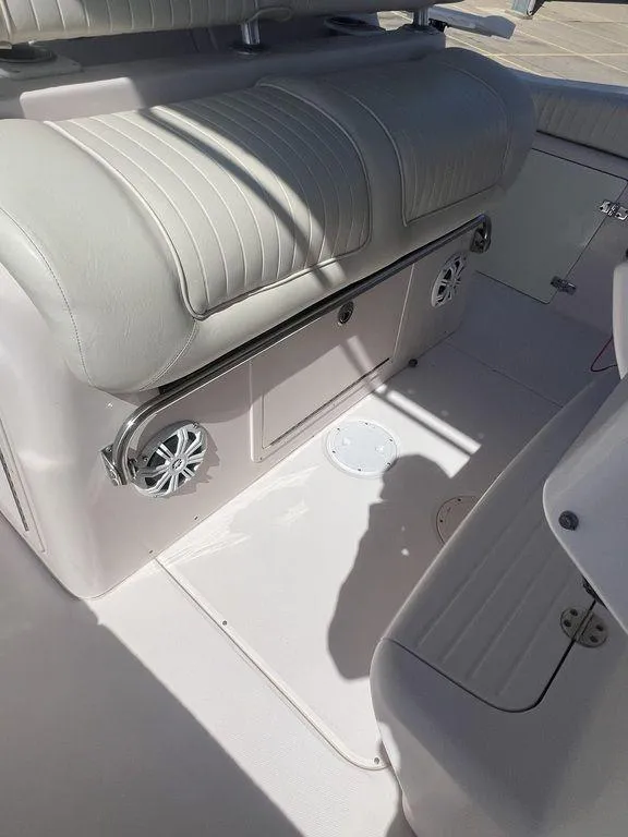 Slide: The Image of 2003 Grady-White 306 Bimini boat interior with cushioned seating and built-in speakers. - 42