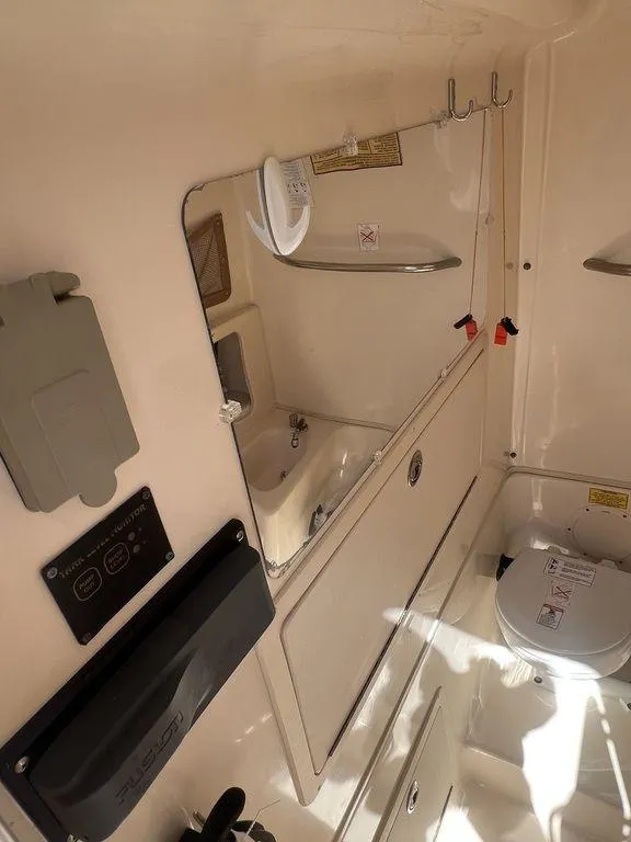 Slide: The Image of 2003 Grady-White 306 Bimini boat interior with sink and toilet. - 43