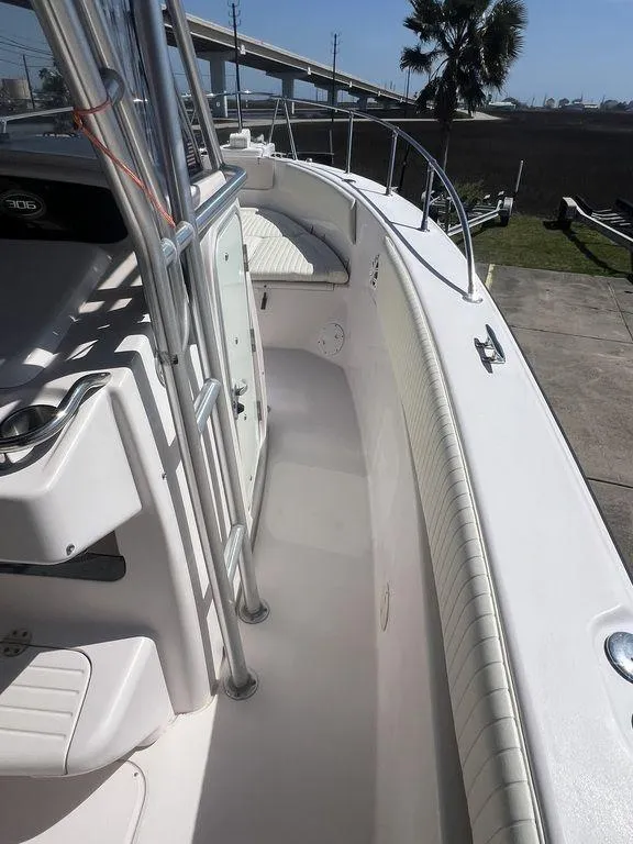Slide: The Image of 2003 Grady-White 306 Bimini boat deck with seating and railing, docked outdoors. - 44