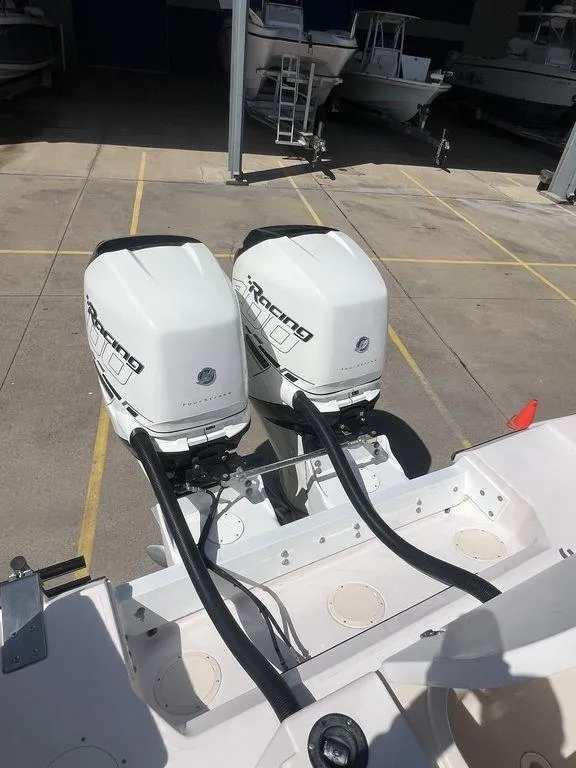 Slide: The Image of 2003 Grady-White 306 Bimini boat with twin outboard motors in a marina. - 46