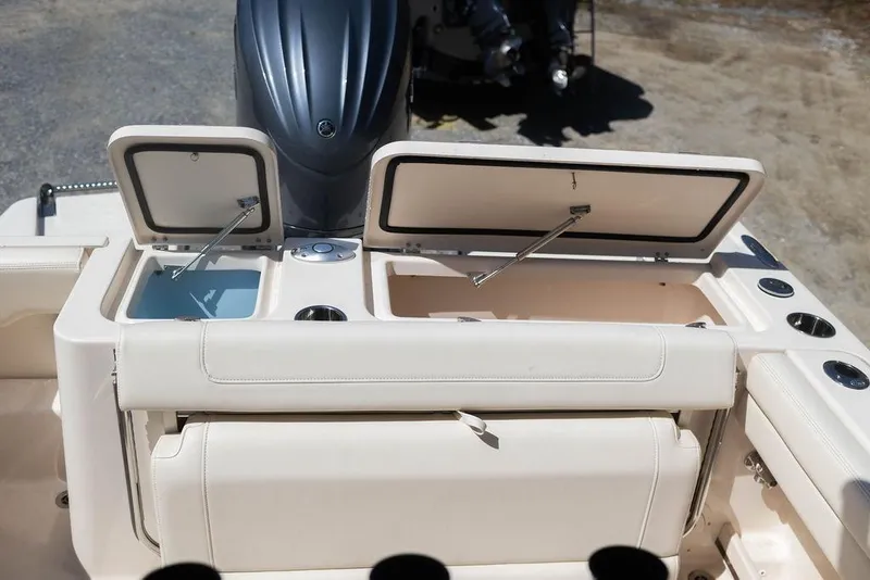Slide: The Image of 2023 Grady-White Fisherman 236 boat with open storage compartments and engine view. - 12