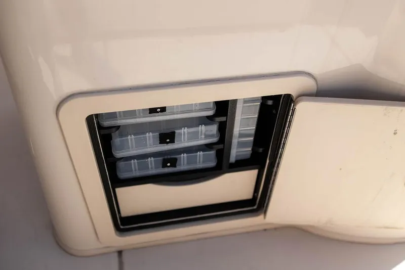 Slide: The Image of Storage compartment on 2023 Grady-White Fisherman 236 boat, featuring organized tackle boxes. - 15