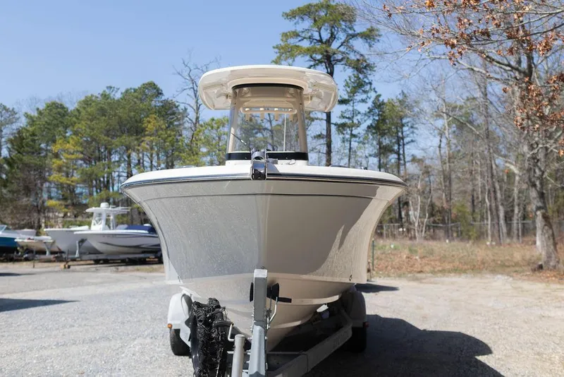 Slide: The Image of 2023 Grady-White Fisherman 236 boat on trailer, surrounded by trees. - 3