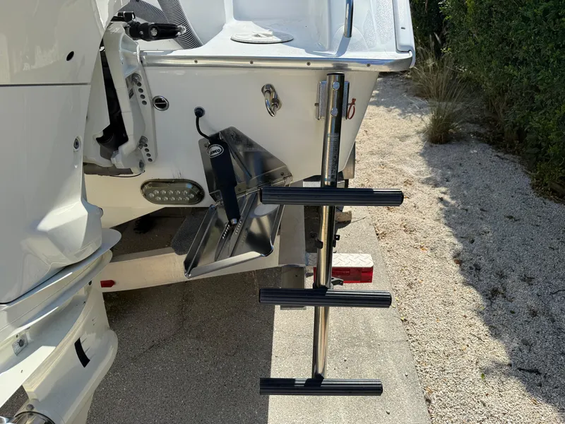 Slide: The Image of 2020 Cape Horn 27 XS boat with a retractable swim ladder on a sunny day. - 11