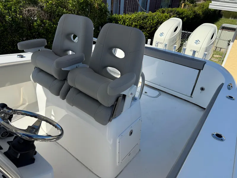Slide: The Image of 2020 Cape Horn 27 XS boat interior with dual gray seats and steering wheel. - 27