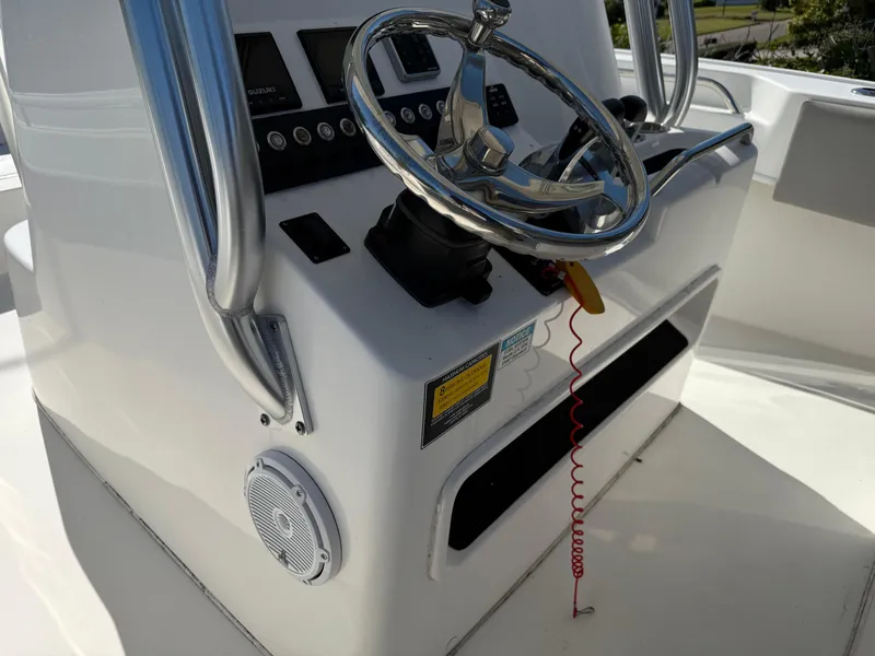 Slide: The Image of 2020 Cape Horn 27 XS boat console with steering wheel and controls. - 41