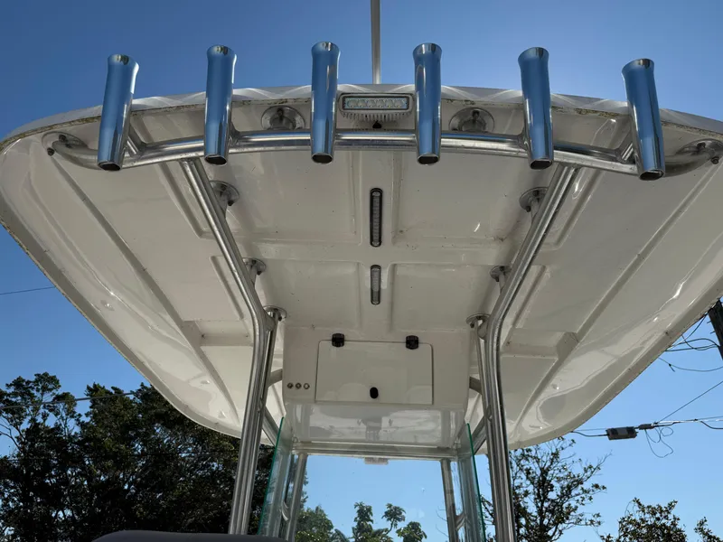 Slide: The Image of 2020 Cape Horn 27 XS boat T-top with rod holders against blue sky. - 49