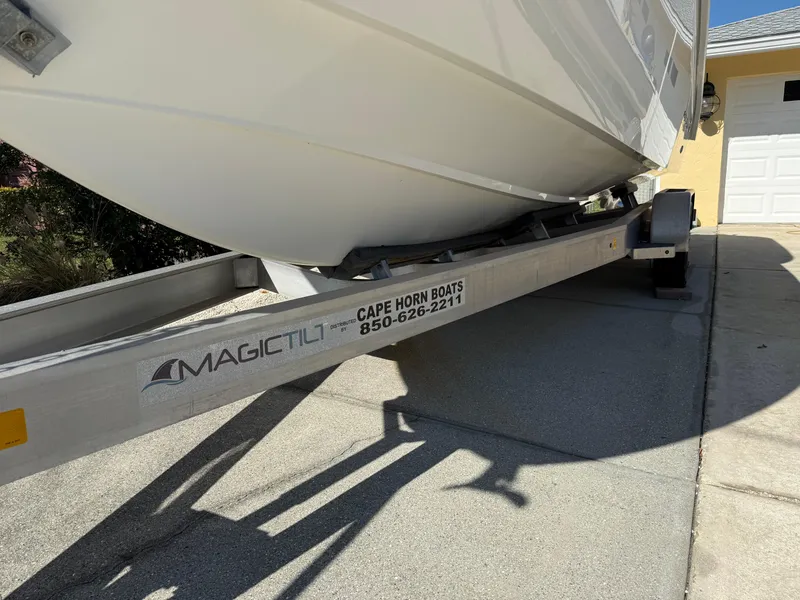 Slide: The Image of 2020 Cape Horn 27 XS boat on Magic Tilt trailer in driveway. - 8