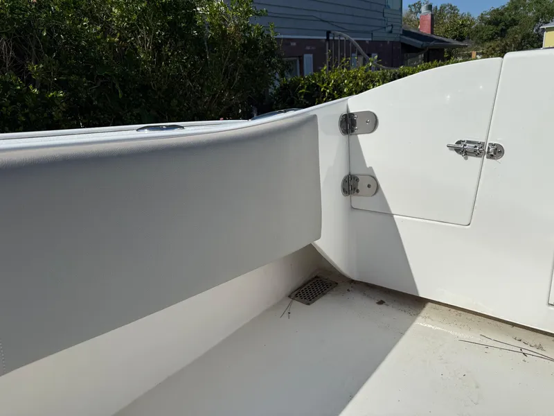 Slide: The Image of 2020 Cape Horn 27 XS boat interior with white seating and storage compartment. - 16