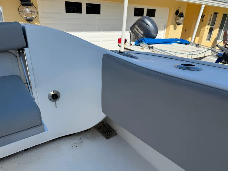 Slide: The Image of 2020 Cape Horn 27 XS boat interior with gray seating and outdoor background. - 17