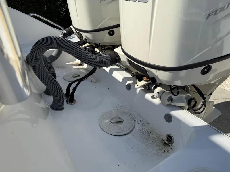 Slide: The Image of 2020 Cape Horn 27 XS boat engine area with dual motors and cables. - 19