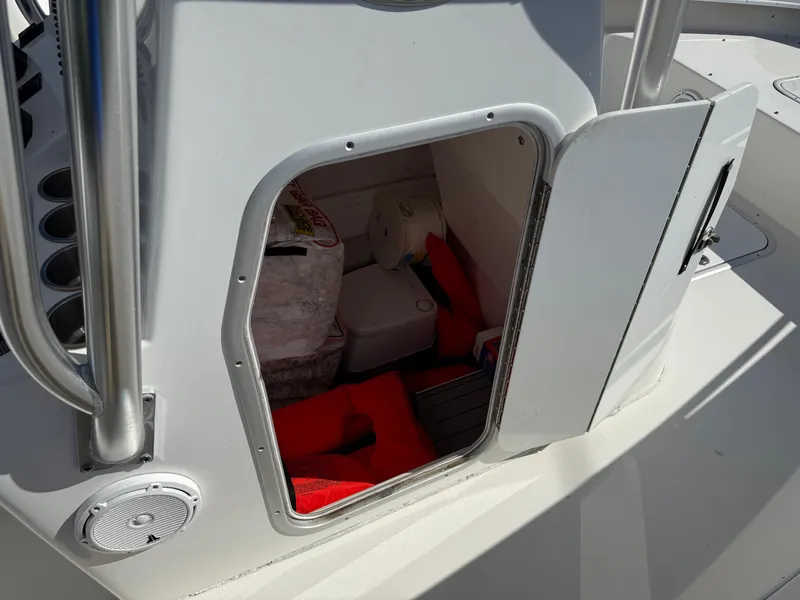 Slide: The Image of 2020 Cape Horn 27 XS boat storage compartment with life jackets and equipment. - 31