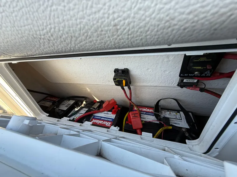 Slide: The Image of Battery compartment of 2020 Cape Horn 27 XS boat, featuring multiple batteries and wiring. - 33