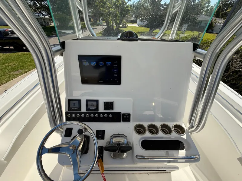 Slide: The Image of 2020 Cape Horn 27 XS boat console with steering wheel, controls, and display screen. - 38