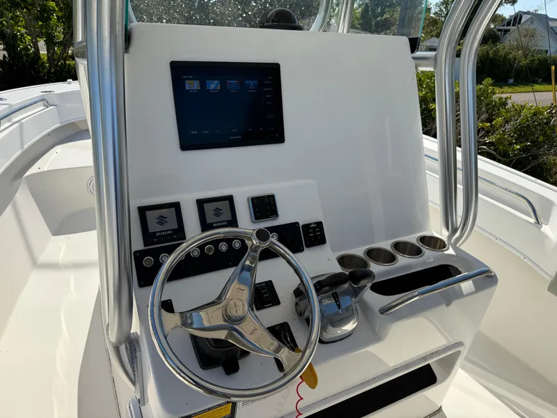 Slide: The Image of 2020 Cape Horn 27 XS boat console with steering wheel and electronic controls. - 39