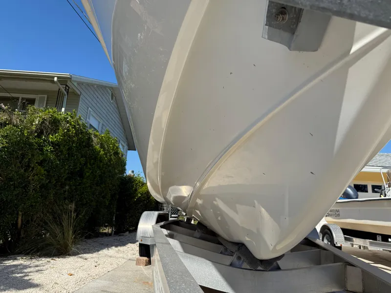Slide: The Image of 2020 Cape Horn 27 XS boat on trailer, viewed from below, with clear blue sky. - 4