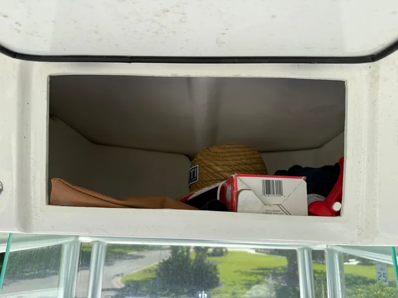 Slide: The Image of Storage compartment in a 2020 Cape Horn 27 XS boat with various items inside. - 47
