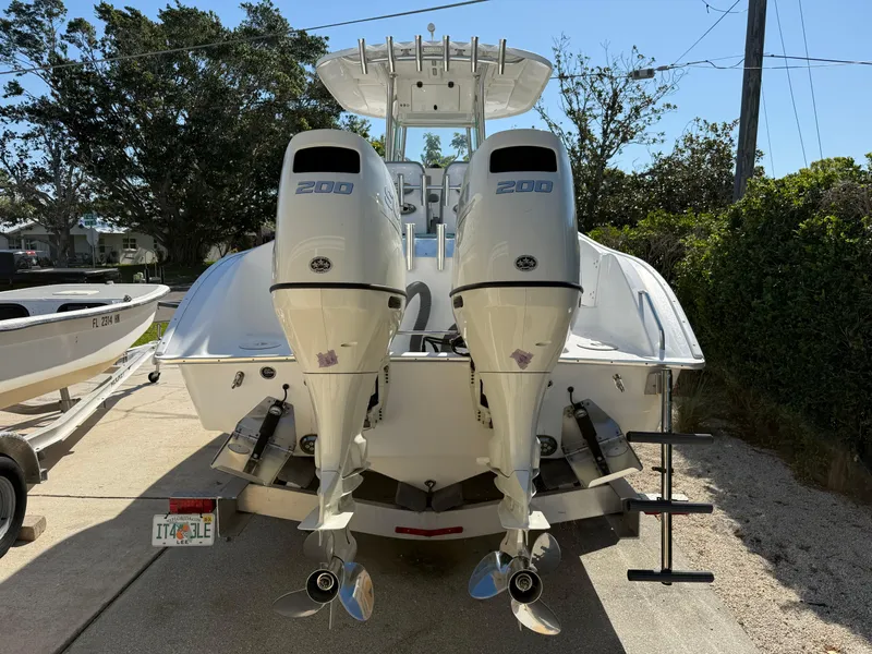 Slide: The Image of 2020 Cape Horn 27 XS boat with dual 200 horsepower engines, parked on a driveway. - 5