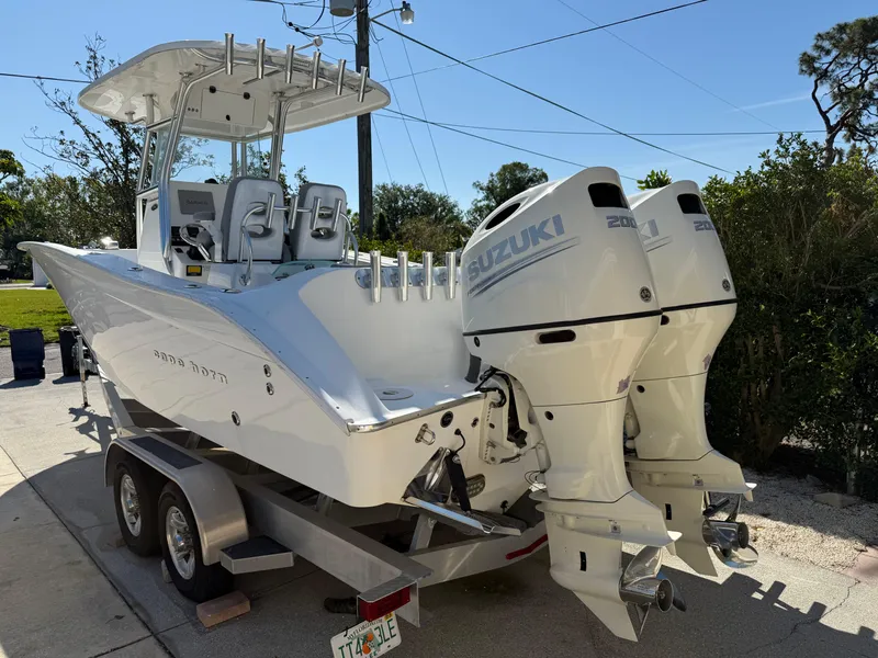 Slide: The Image of 2020 Cape Horn 27 XS boat with dual Suzuki engines on a trailer. - 6