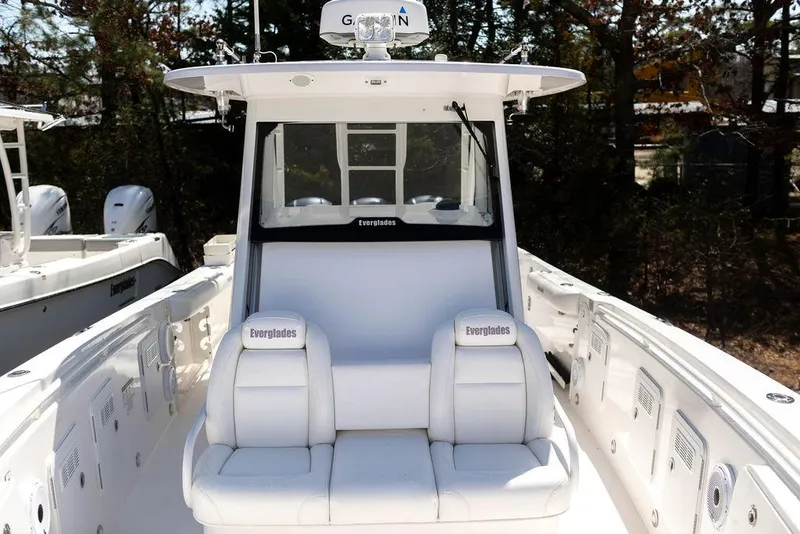 Slide: The Image of 2015 Everglades 355 Center Console boat with white seating and sleek design. - 10