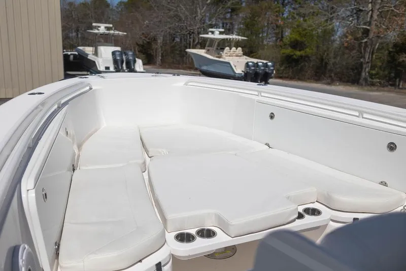Slide: The Image of 2015 Everglades 355 Center Console boat with spacious seating area and cup holders. - 11