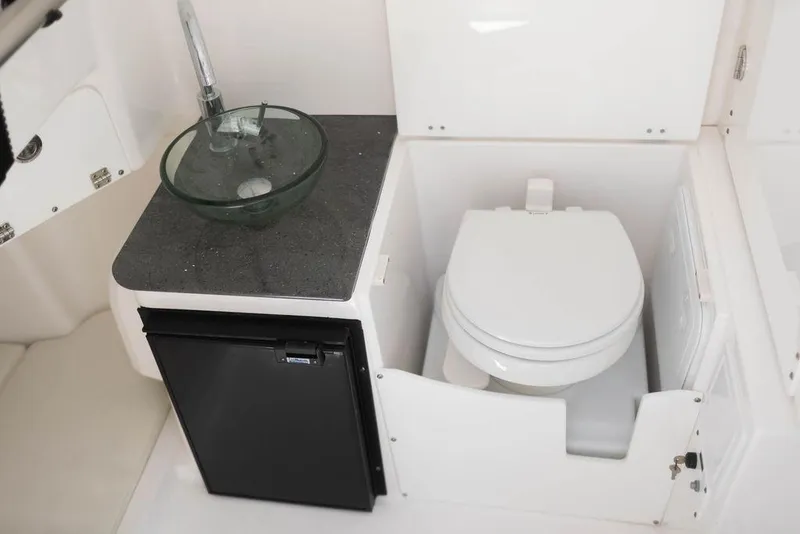 Slide: The Image of Interior of 2015 Everglades 355 Center Console with sink, toilet, and mini fridge. - 14