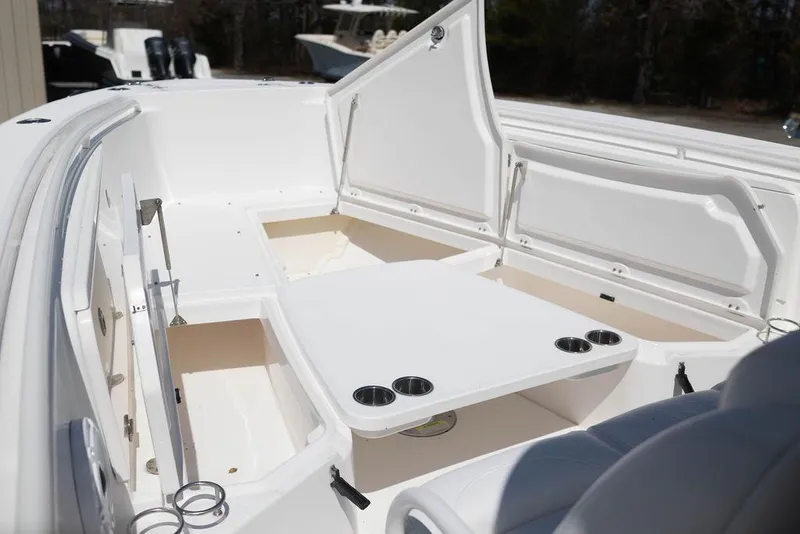 Slide: The Image of 2015 Everglades 355 Center Console boat with open storage compartments and cup holders. - 17