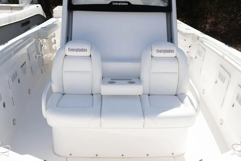 Slide: The Image of 2015 Everglades 355 Center Console boat with white seating and cup holders. - 18