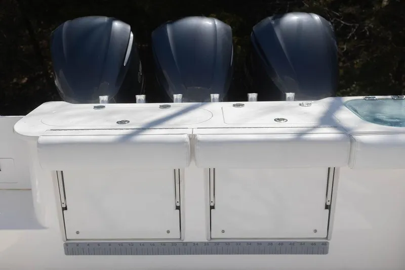 Slide: The Image of 2015 Everglades 355 Center Console with triple outboard engines, featuring a sleek white deck. - 23