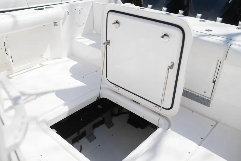 Slide: The Image of 2015 Everglades 355 Center Console boat with open storage compartment on deck. - 26