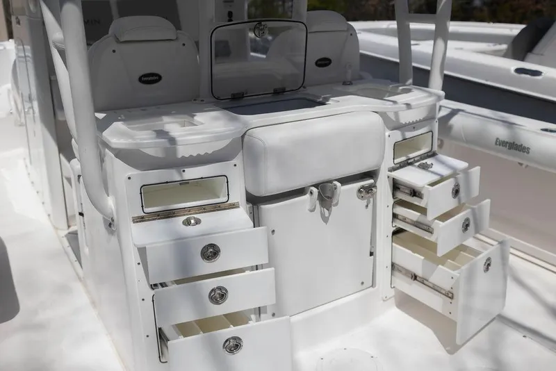 Slide: The Image of 2015 Everglades 355 Center Console boat with open storage compartments and seating area. - 29