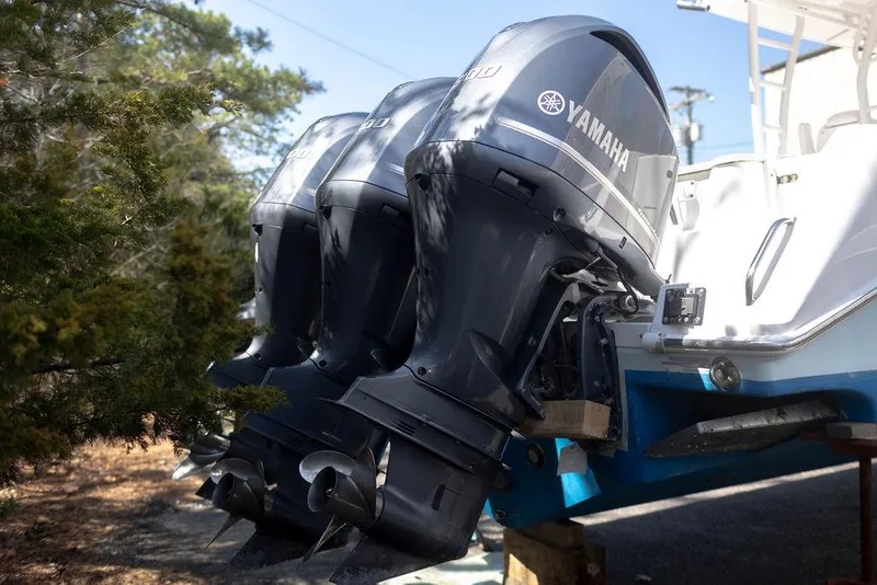 Slide: The Image of Triple Yamaha outboard motors on a 2015 Everglades 355 Center Console boat. - 4