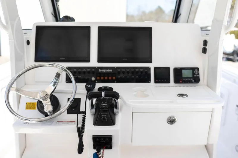 Slide: The Image of Control panel of 2015 Everglades 355 Center Console boat with dual screens and steering wheel. - 7