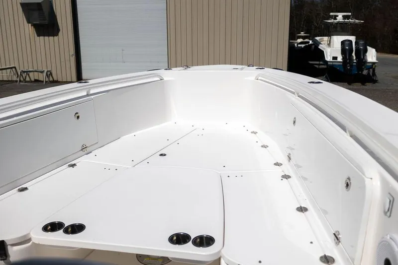 Slide: The Image of 2015 Everglades 355 Center Console boat interior, featuring spacious white deck and cup holders. - 9