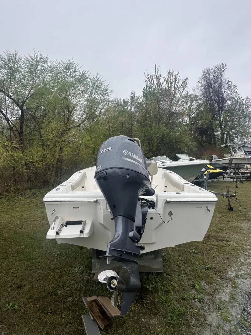 Slide: The Image of 2025 Key West 179 FS boat with Yamaha outboard motor, parked on grassy area. - 3