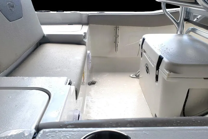 Slide: The Image of 2025 Key West 179 FS boat interior with seating and cooler, featuring a sleek, wet deck design. - 5